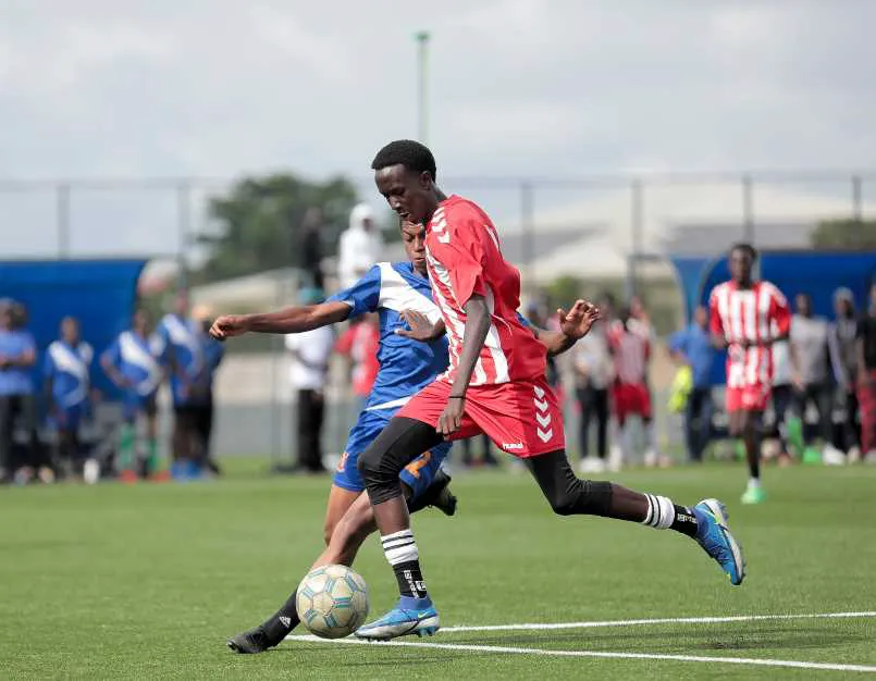 Jerome shielding ball vs Kings Academy during Moi Cup